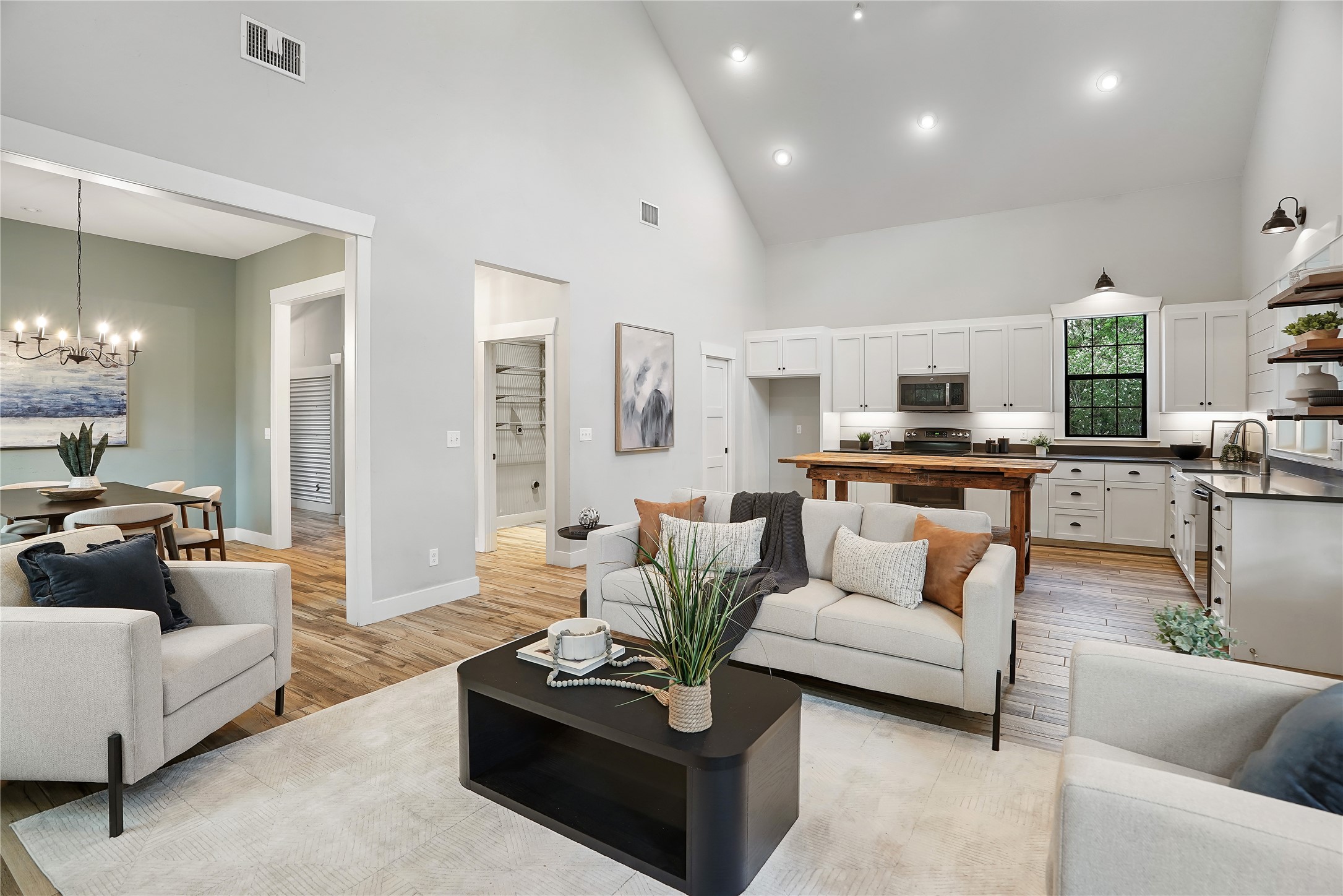 786 Beauchamp Road Dripping Springs, TX 78620 - Photo 9 of 40 The property features an open-concept living area with vaulted ceilings, recessed lighting, and light wood flooring