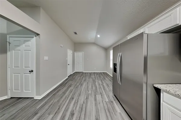 a view of hallway with wooden floor