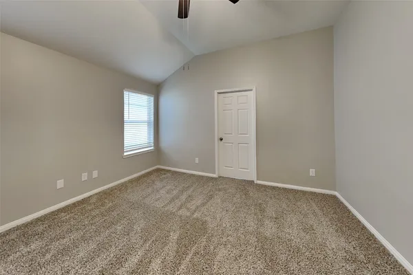 an empty room with windows and closet