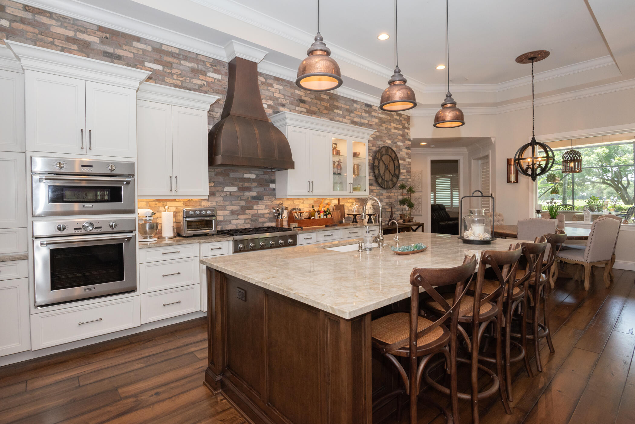 3420 Southeast Golf Trail Stuart, FL 34997 - Photo 11 of 63 a kitchen with a table chairs stove and microwave