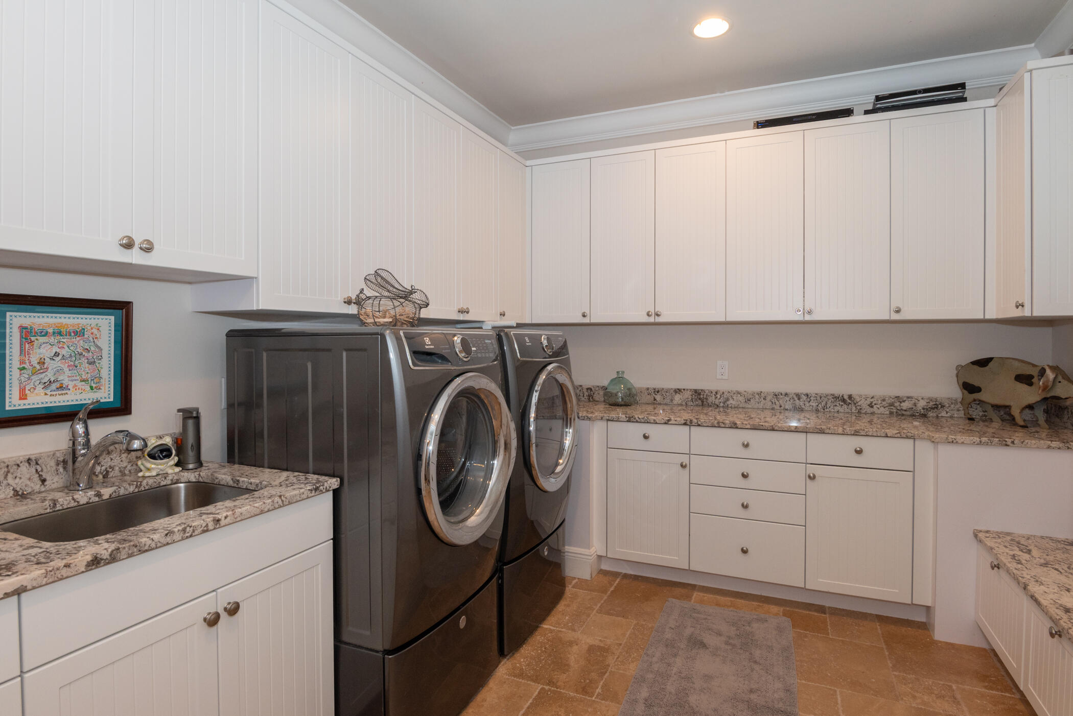 3420 Southeast Golf Trail Stuart, FL 34997 - Photo 16 of 63 a utility room with granite countertop a sink and a washer dryer
