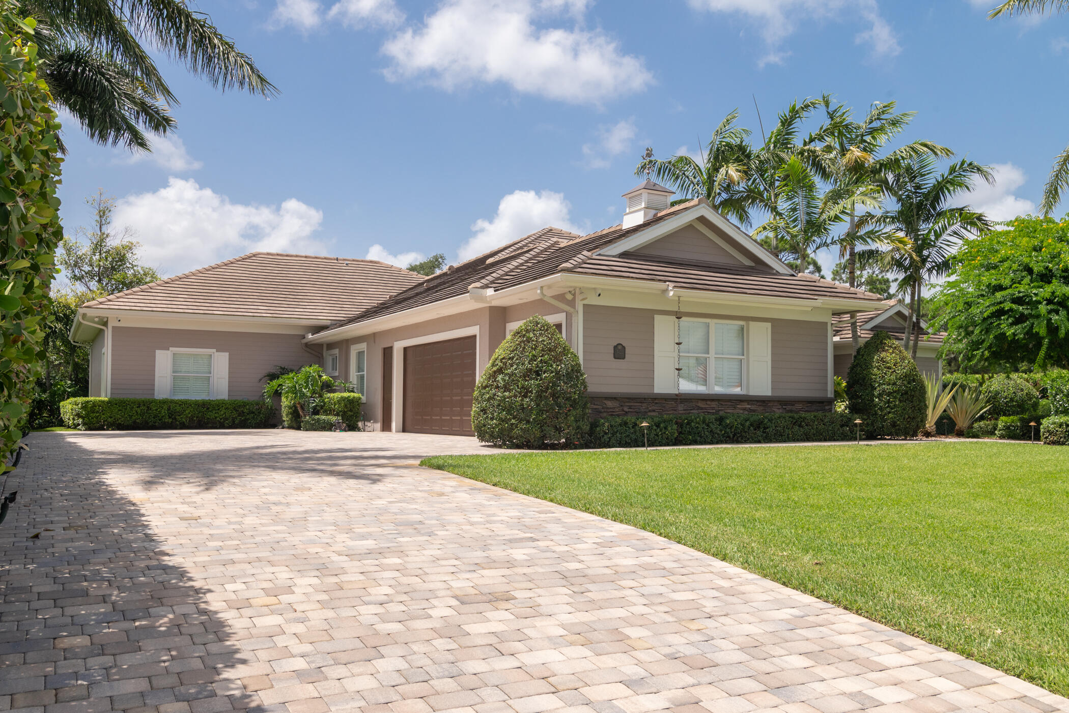3420 Southeast Golf Trail Stuart, FL 34997 - Photo 3 of 63 a front view of a house with a garden