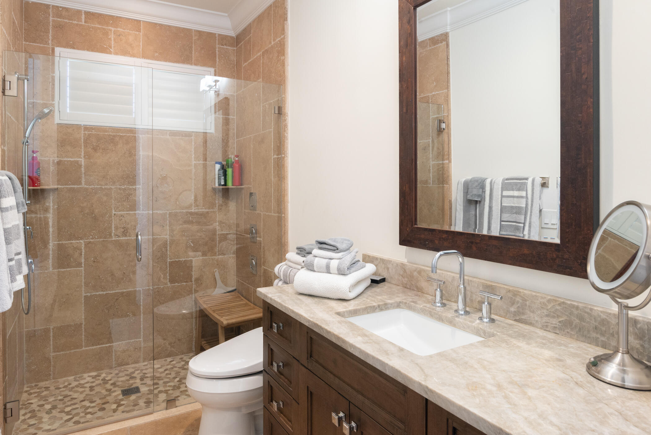 3420 Southeast Golf Trail Stuart, FL 34997 - Photo 38 of 63 a bathroom with a granite countertop sink a toilet a mirror and shower