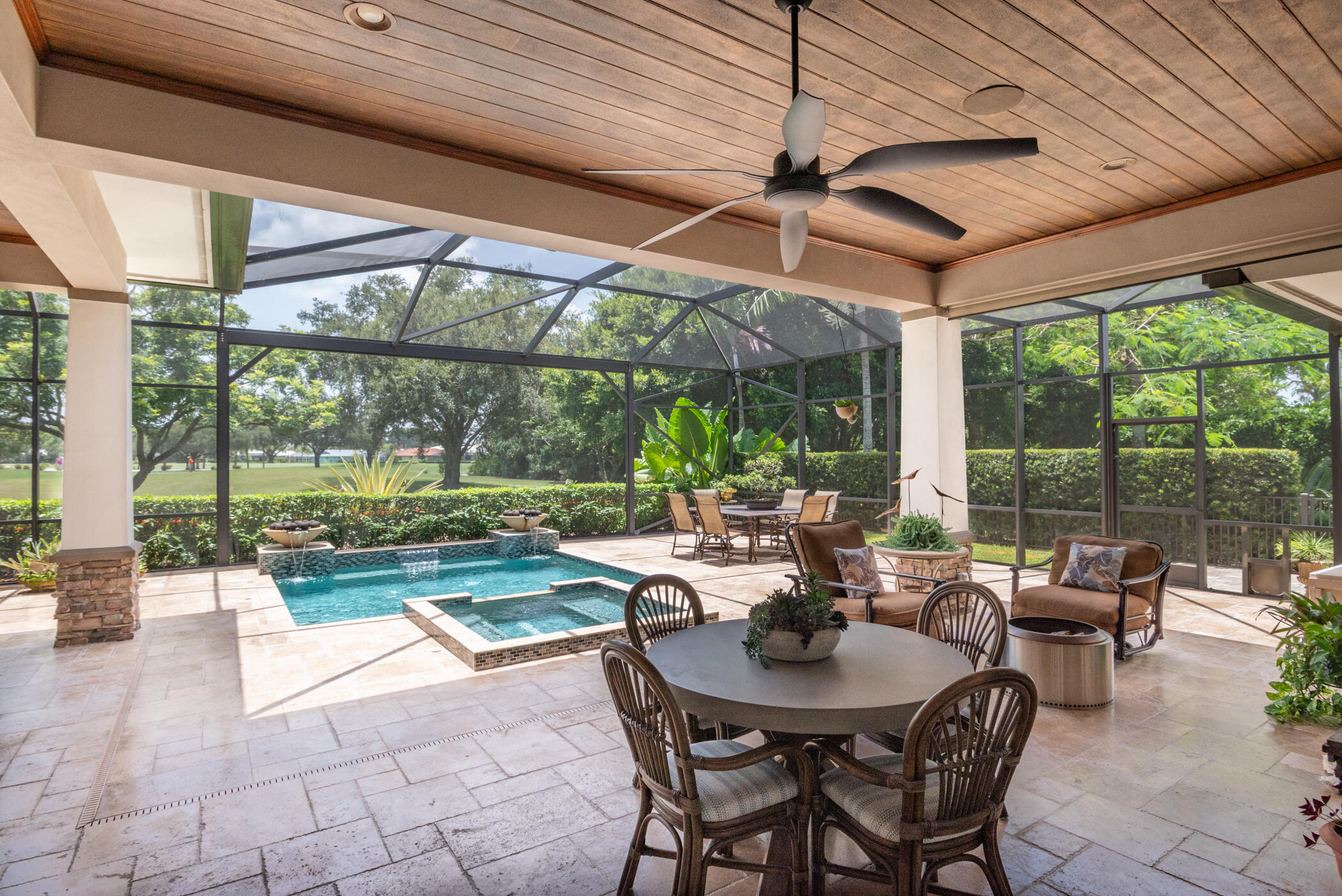 3420 Southeast Golf Trail Stuart, FL 34997 - Photo 41 of 63 a view of a patio with a dining table and chairs under an umbrella