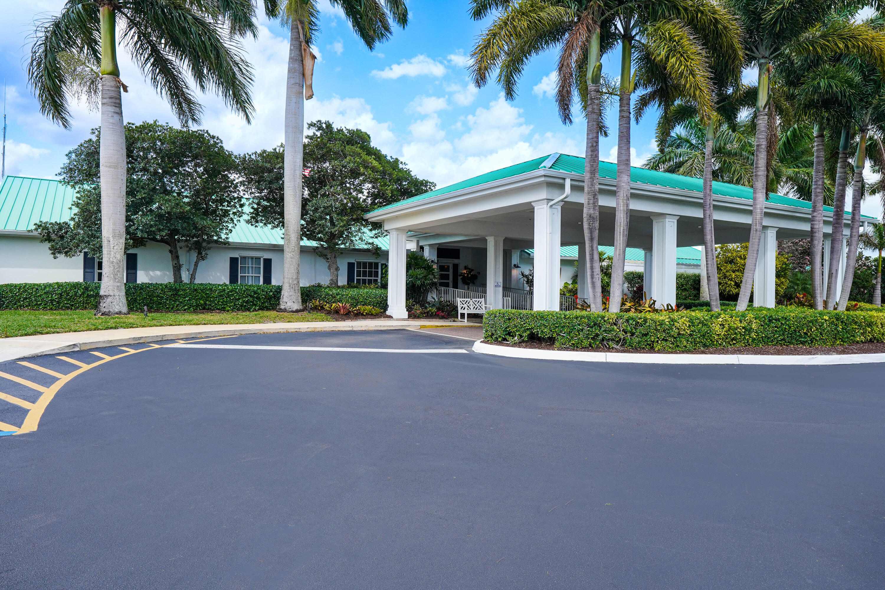 3420 Southeast Golf Trail Stuart, FL 34997 - Photo 51 of 63 front view of a house with a yard and palm trees