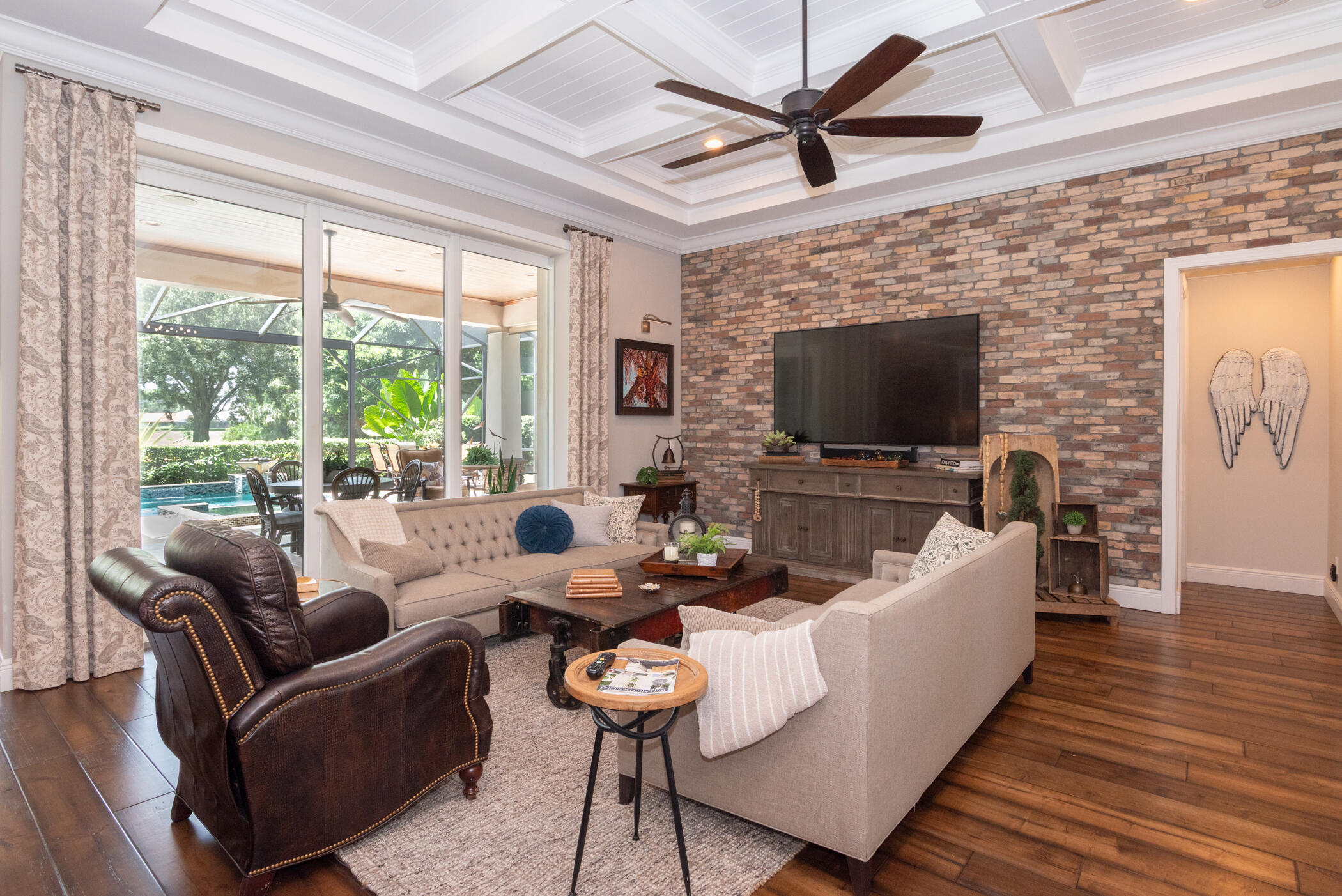 3420 Southeast Golf Trail Stuart, FL 34997 - Photo 6 of 63 a living room with furniture a flat screen tv and a large window