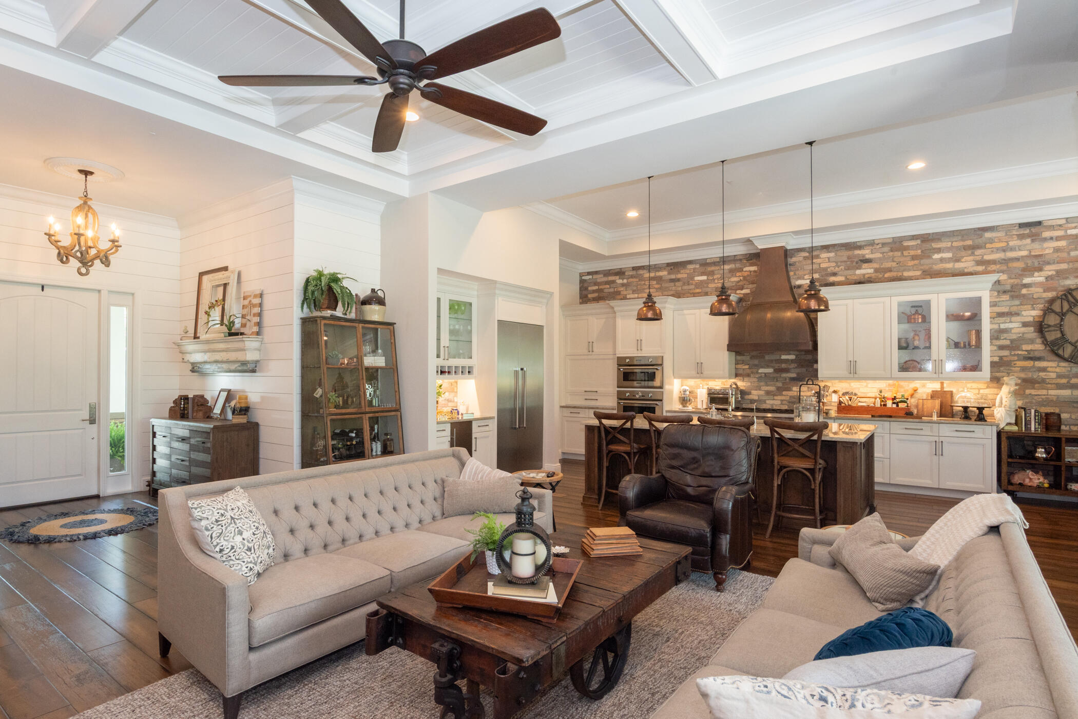 3420 Southeast Golf Trail Stuart, FL 34997 - Photo 8 of 63 a living room with furniture kitchen view and a chandelier
