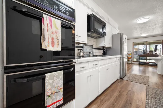 a kitchen with a sink cabinets and wooden floor