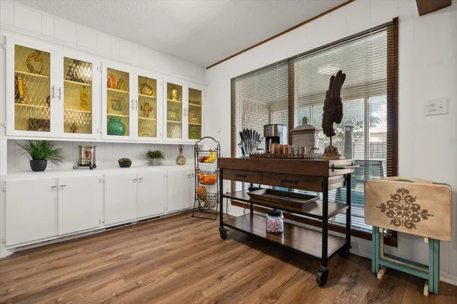 a view of a workspace with furniture and window
