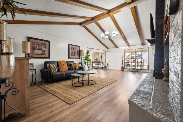 a view of a livingroom with furniture a ceiling fan and window