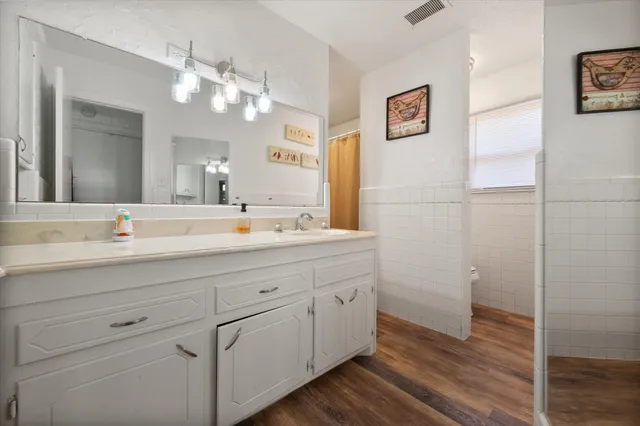 a bathroom with a sink a vanity and a mirror