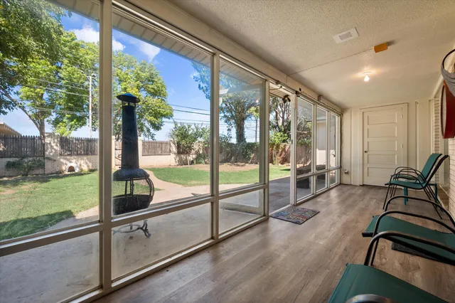 a view of a porch with furniture and garden