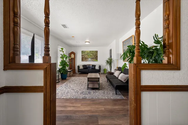 a living room with furniture a flat screen tv and a fireplace