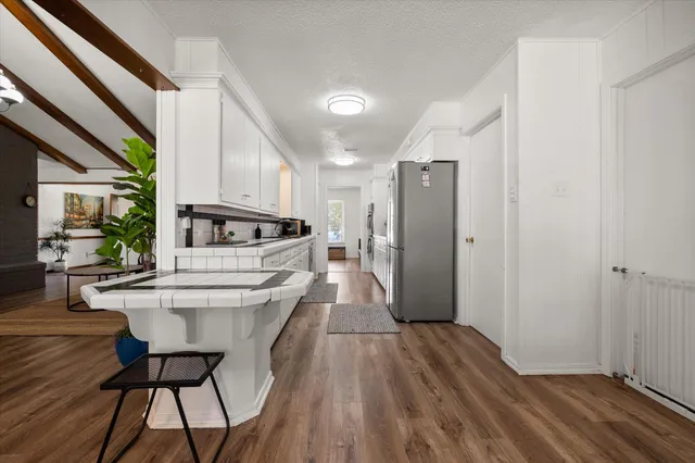 a kitchen with stainless steel appliances a sink and a refrigerator