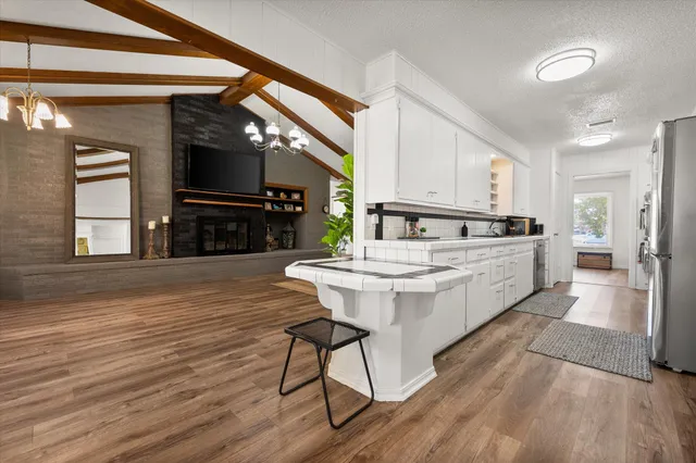a kitchen with white cabinets and a sink