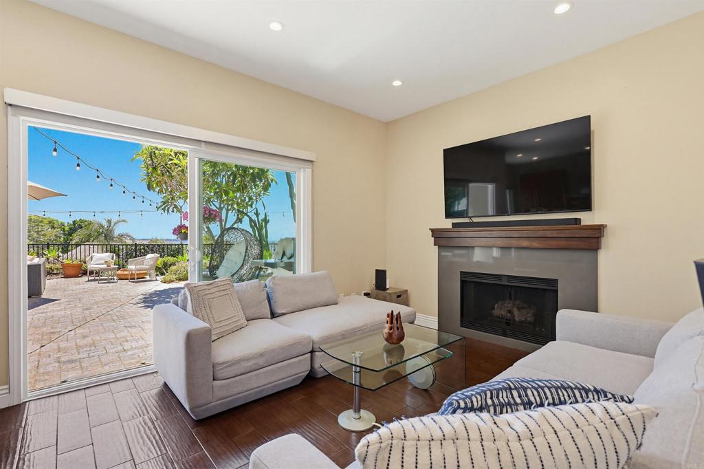 2756 Southampton Road Carlsbad, CA 92010 - Photo 12 of 40 a living room with furniture fireplace and a flat screen tv
