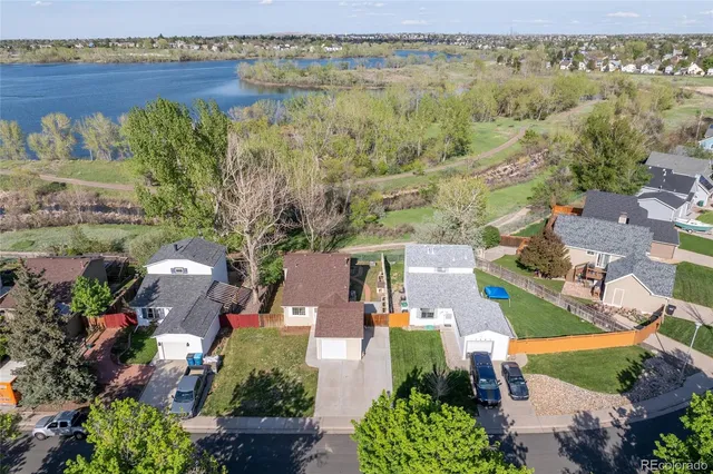 an aerial view of residential house with outdoor space and lake view