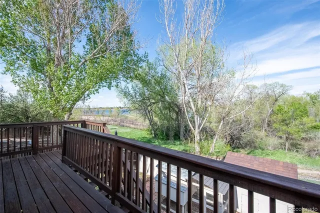 a balcony with wooden floor and fence