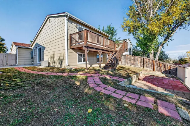 a view of a wooden fence and a tree
