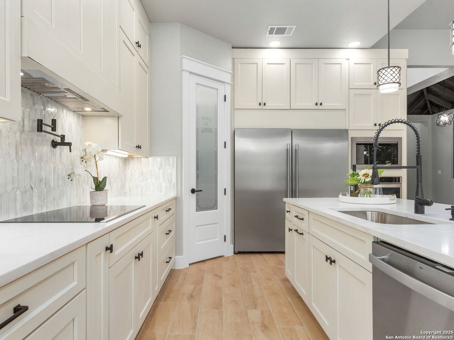 1475 Echo Meadow Lane Spring Branch, TX 78070 - Photo 13 of 25 a kitchen with kitchen island white cabinets and refrigerator