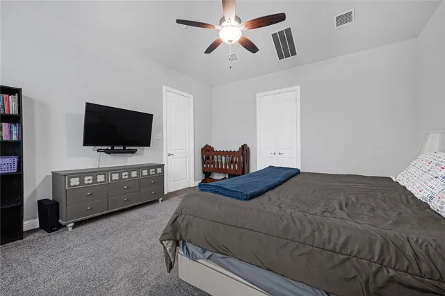 a bedroom with a bed and large window
