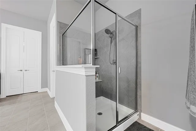 a large bathroom with a double vanity sink large mirror and a bathtub