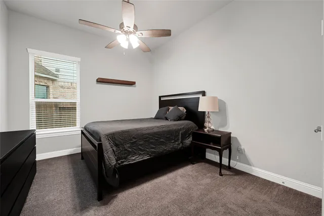 a living room with furniture a ceiling fan and a window