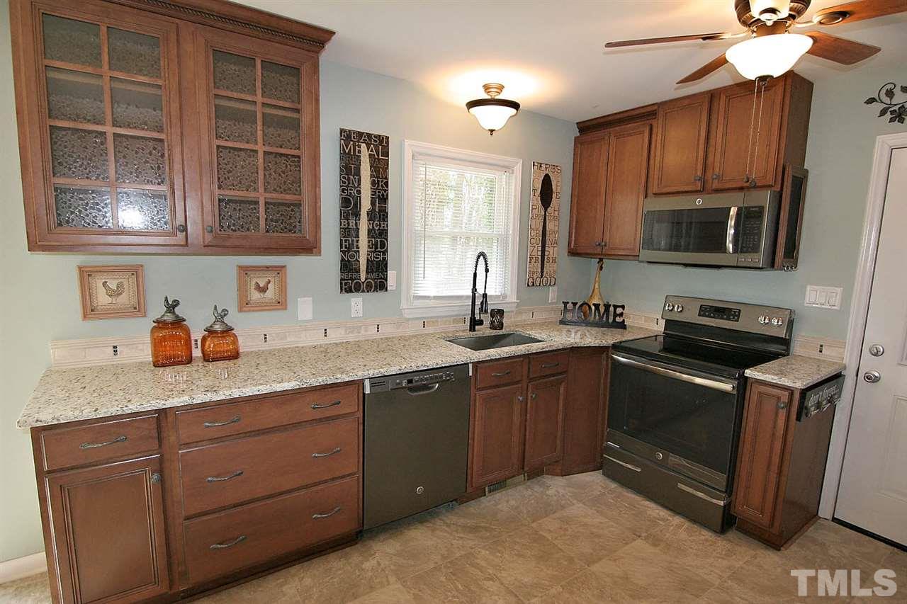3404 Victor Place Raleigh, NC 27604 - Photo 5 of 22 a kitchen with stainless steel appliances granite countertop a sink stove and microwave