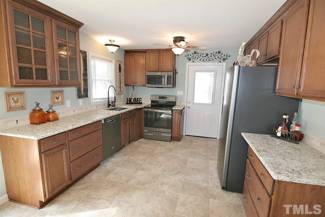 3404 Victor Place Raleigh, NC 27604 - Photo 6 of 22 a kitchen with stainless steel appliances granite countertop a sink stove and refrigerator