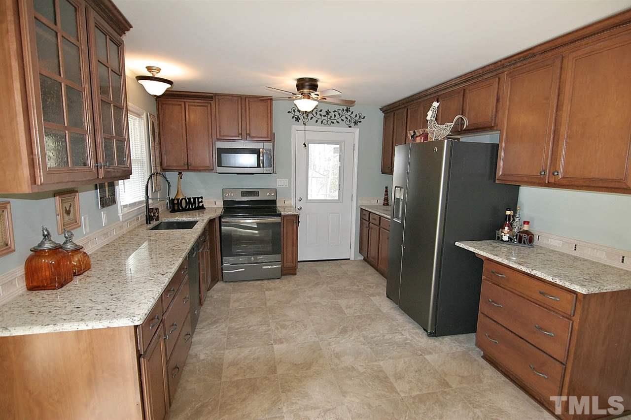 3404 Victor Place Raleigh, NC 27604 - Photo 7 of 22 a kitchen with granite countertop a refrigerator stove and sink
