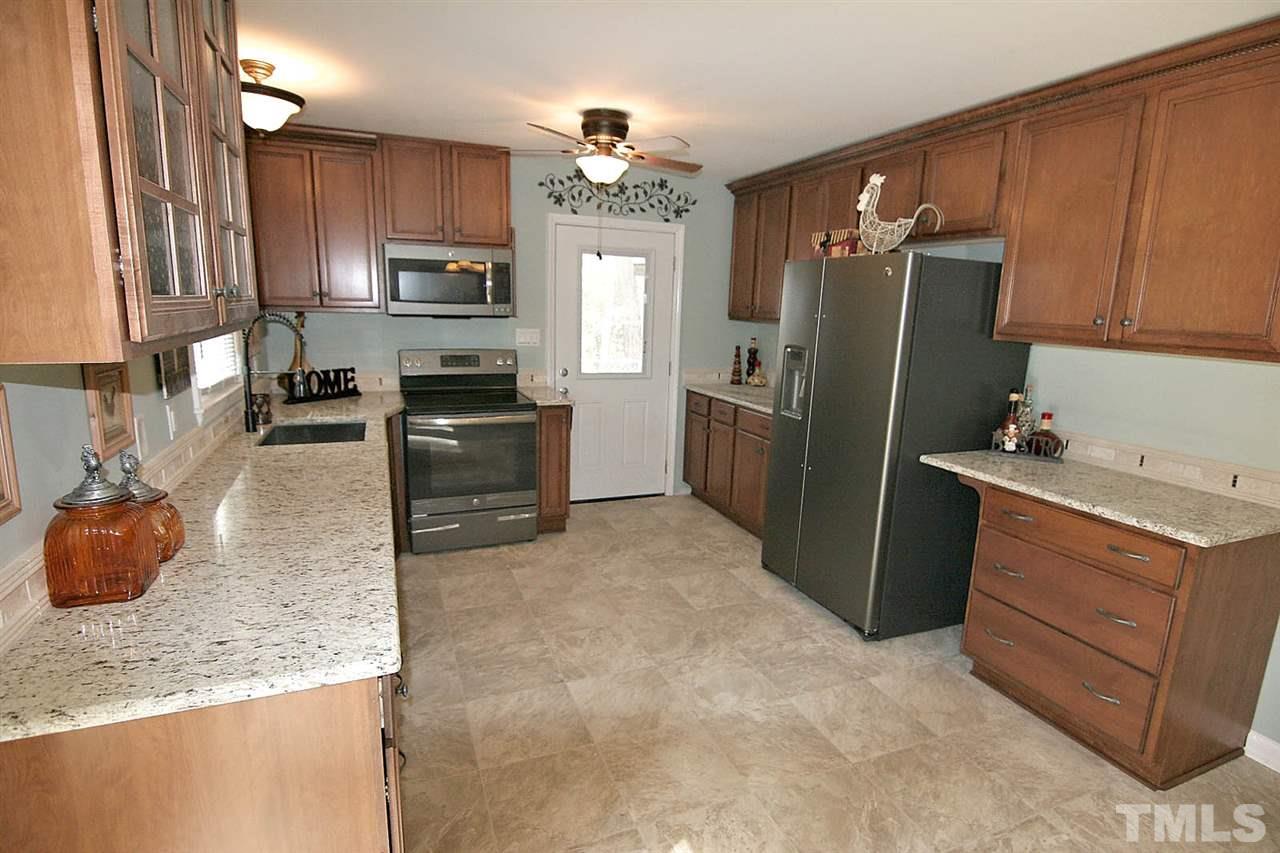 3404 Victor Place Raleigh, NC 27604 - Photo 9 of 22 a kitchen with granite countertop a refrigerator stove and sink