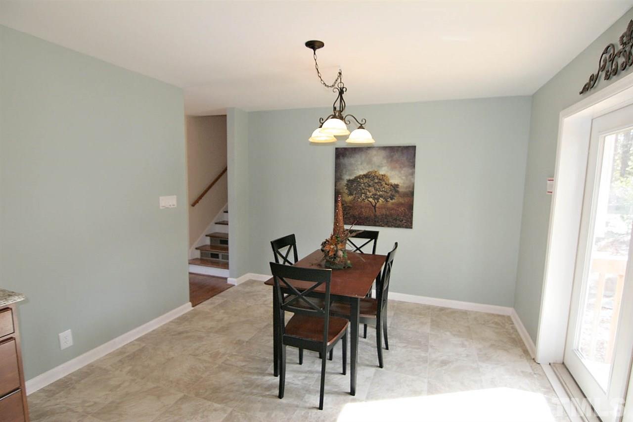 3404 Victor Place Raleigh, NC 27604 - Photo 10 of 22 a view of a dining room with furniture and chandelier