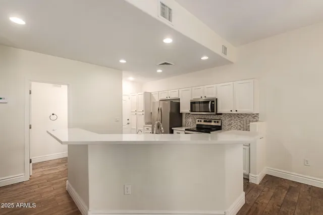 a kitchen with stainless steel appliances a sink and a refrigerator