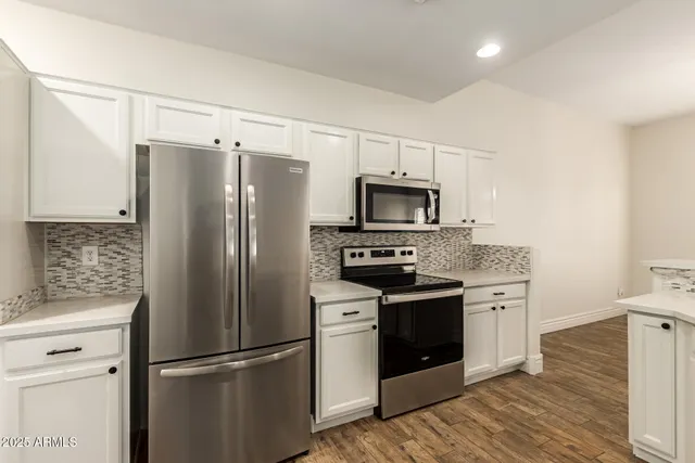 a kitchen with stainless steel appliances a refrigerator stove and microwave
