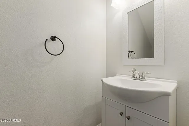 a bathroom with a sink and mirror