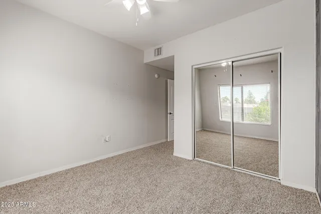 an empty room with a fan