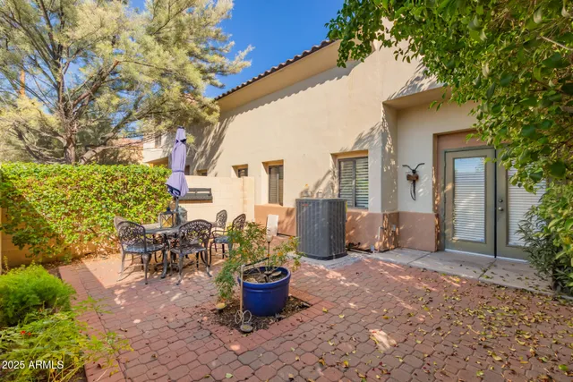 a building outdoor space with patio furniture and potted plants