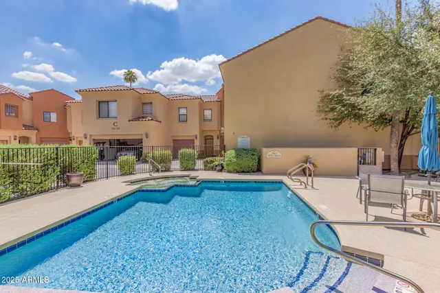 a view of a house with swimming pool and sitting area