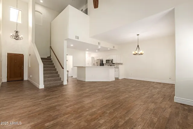 a view of a kitchen with wooden floor and staircase