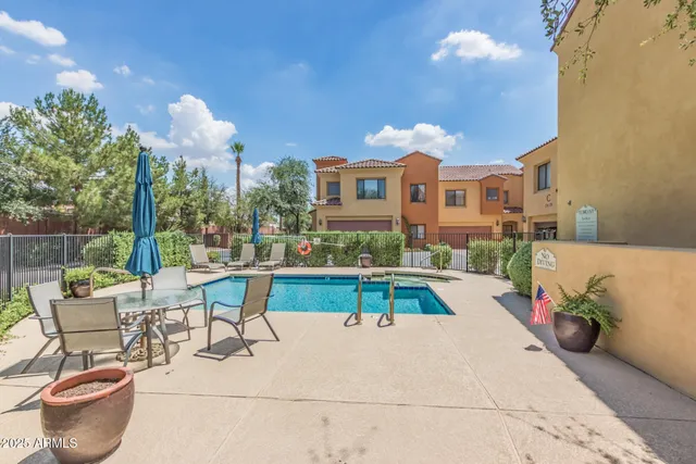 a view of a house with swimming pool and sitting area
