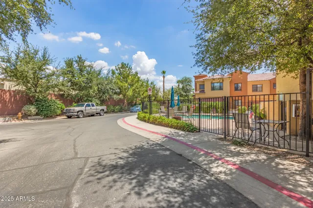a view of a park with iron fence