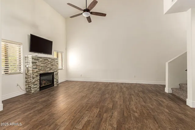 a view of empty room with wooden floor and fireplace
