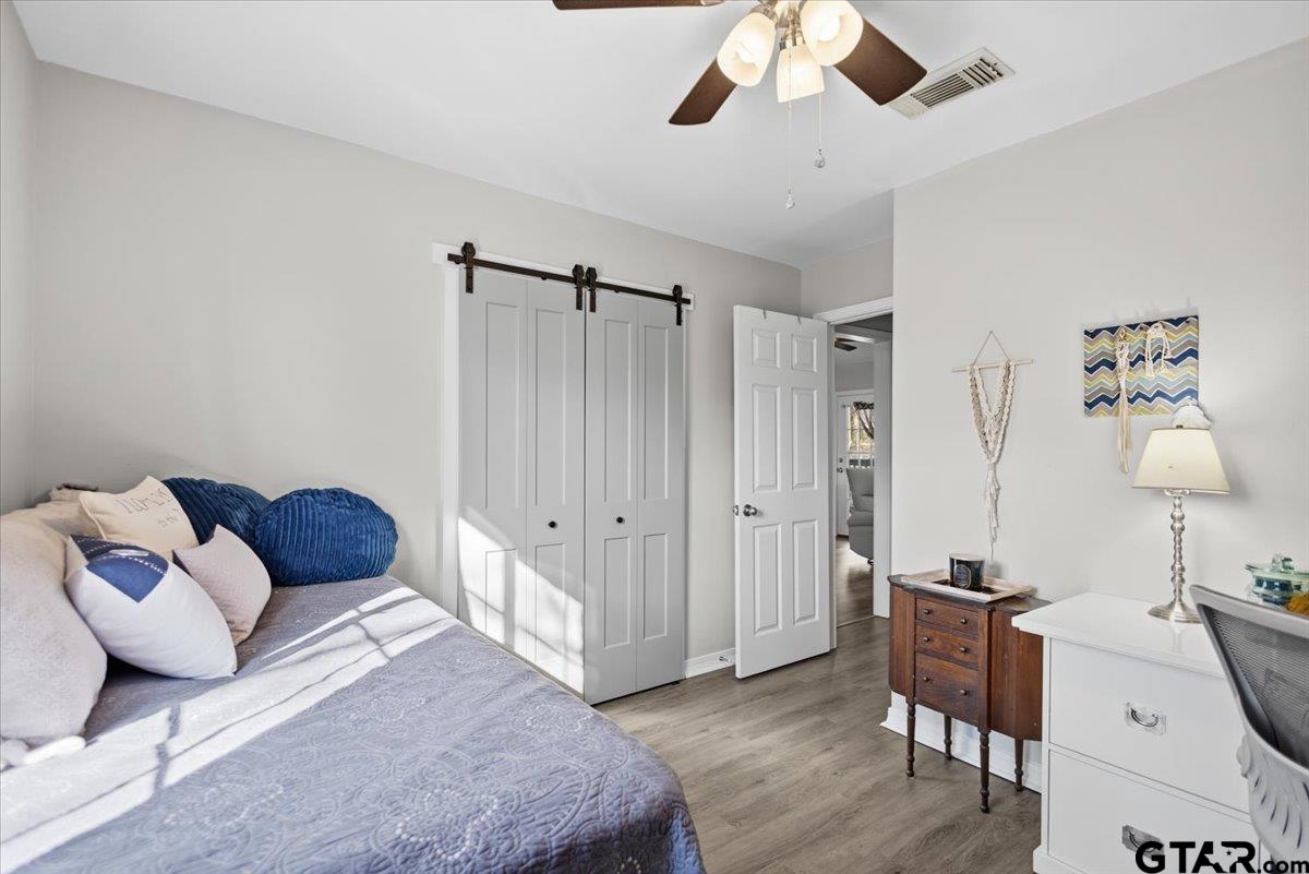 289 Acapulco Road Jefferson, TX 75657 - Photo 17 of 30 a bedroom with a bed and a chandelier