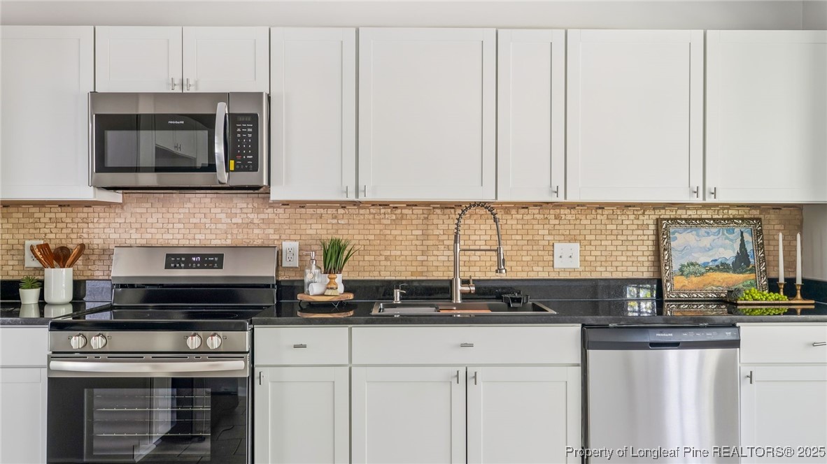 316 Patterson Street Raeford, NC 28376 - Photo 13 of 39 a kitchen with stainless steel appliances granite countertop white cabinets and a stove a sink