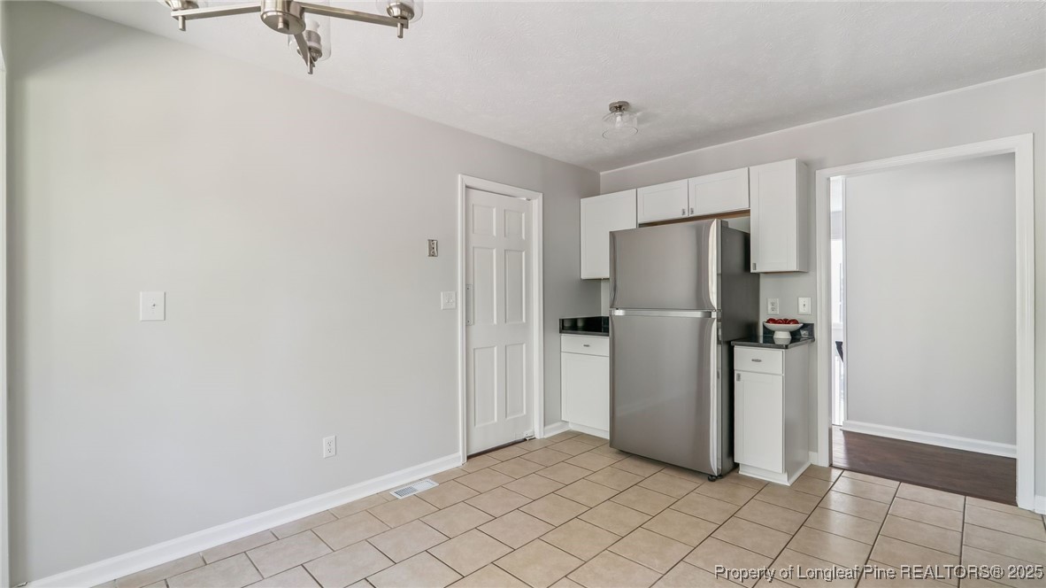 316 Patterson Street Raeford, NC 28376 - Photo 14 of 39 a view of a refrigerator in kitchen and white cabinets