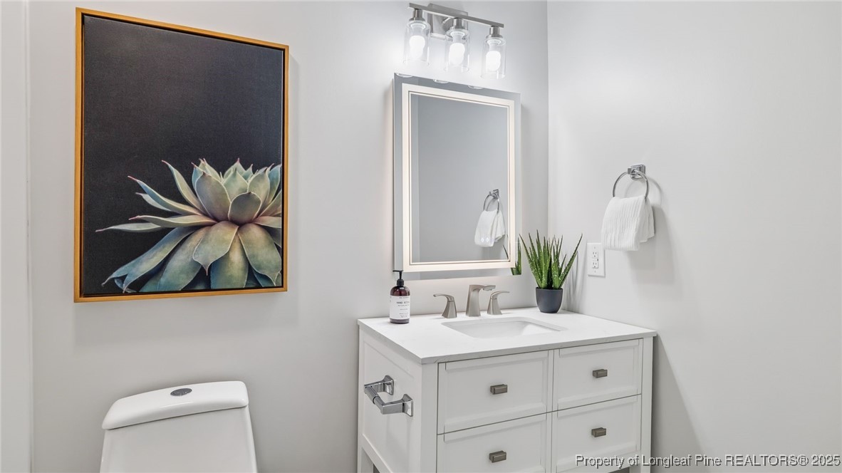 316 Patterson Street Raeford, NC 28376 - Photo 22 of 39 a bathroom with a sink vanity and a mirror