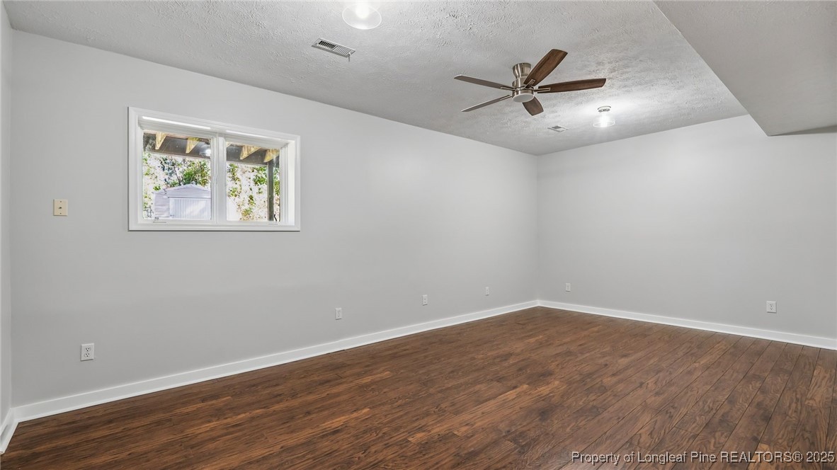 316 Patterson Street Raeford, NC 28376 - Photo 26 of 39 an empty room with wooden floor and windows