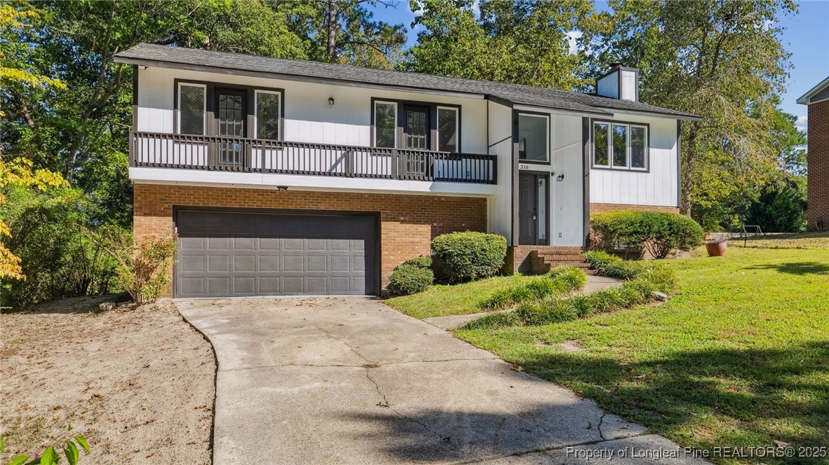 316 Patterson Street Raeford, NC 28376 - Photo 3 of 39 a front view of a house with garden