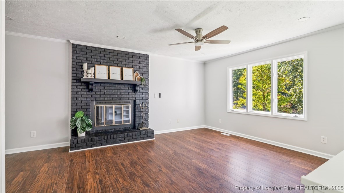 316 Patterson Street Raeford, NC 28376 - Photo 4 of 39 a view of empty room with wooden floor and fan