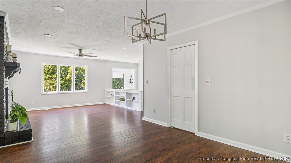 316 Patterson Street Raeford, NC 28376 - Photo 9 of 39 a view of a room with wooden floor potted plants and a chandelier